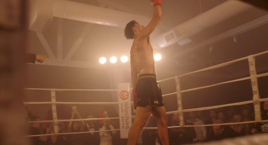 Fighter celebrating victory in the ring